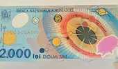 Bancnota de 2.000 de lei din 1999, vânată de colecționari. Cât poate valora astăzi moneda emisă pentru eclipsa totală de Soare