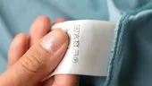 Ce semnifică simbolurile ASCUNSE de pe etichetele hainelor? Semnele mici care îți pot salva garderoba
